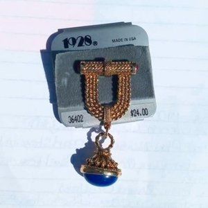 VTG "1928" GOLD TONE U SHAPED W/BAR W/RED STONE ENDS LG BLUE DANGLE STONE BOTTOM